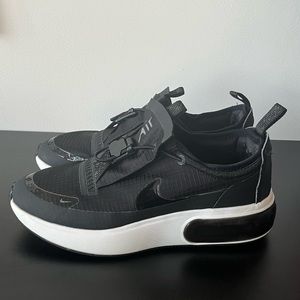 Good condition used Nike slide on sneakers. Womens size 9.5. Black/ white